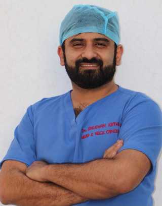 Dr Bhushan Kathuria in surgical scrubs