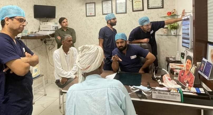 Dr Bhushan Kathuria and the clinical team reviewing scans