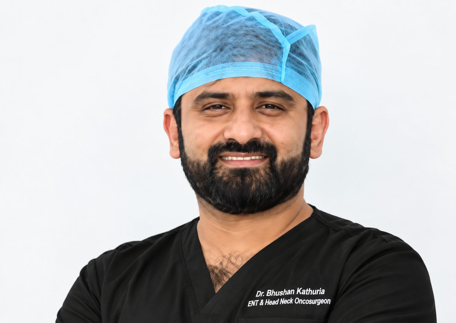 Dr Bhushan Kathuria in black surgical scrubs